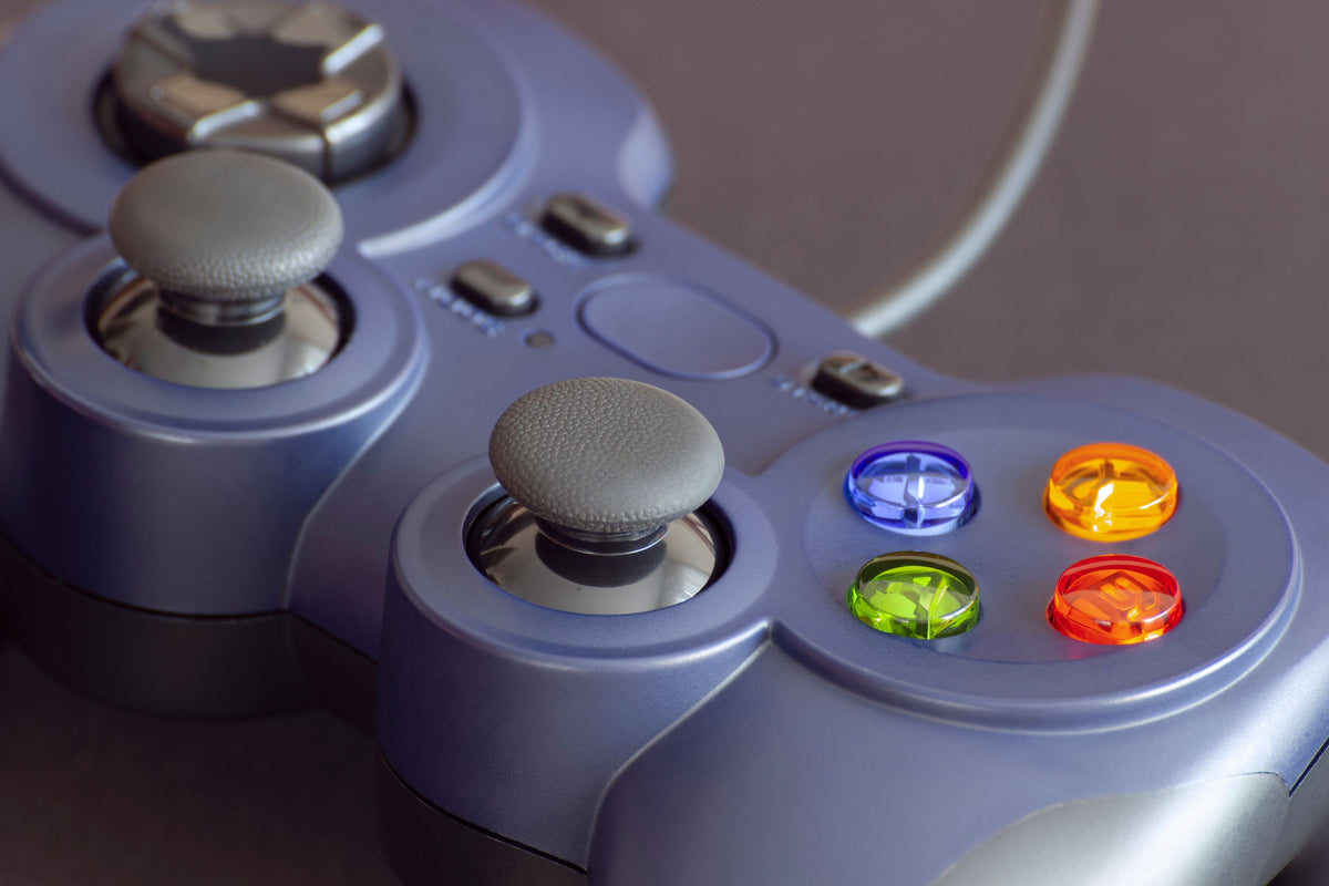 Close-up of a game controller with colorful face buttons