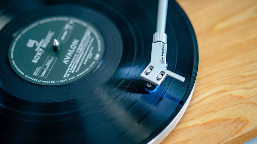 Close-up of a turntable needle on a spinning vinyl record